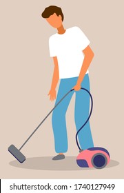 Young guy cleaning floor from dirt with vacuum cleaner. Home everyday activity during quarantine time, spreading covid-19, world epidemic. Isolated character making home work. Housekeeping concept