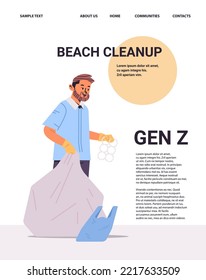 Young Guy Collecting Trash Into Bag Beach Cleanup Generation Z Lifestyle Concept New Modern Demography Trend