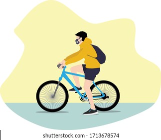 Young guy riding a bicycle, wearing a face mask