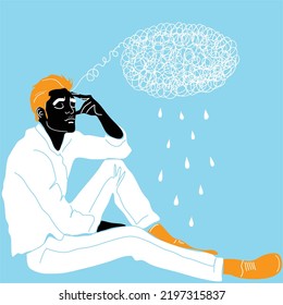 A young guy is sitting and holding his head with his hand meditating. Sadness, depression and thoughts. The concept of excitement, insecurity, mental illness, sadness and fatigue