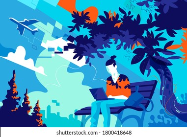 A young guy sitting on the bench at the park working on the laptop