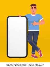 Young handsome happy man points to the screen of a huge smartphone. Advertising of a mobile application or services, promotion of an application or website. Vector illustration on a yellow background.