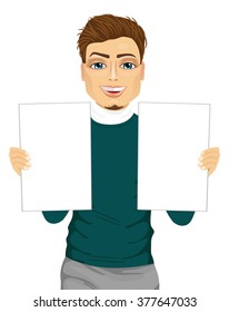 young handsome man holding two blank papers isolated on white background