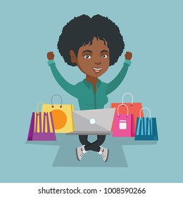 Young happy african-american woman sitting with arms up among shopping bags and using a laptop for online shopping. Cheerful woman buying purchases online. Vector cartoon illustration. Square layout.