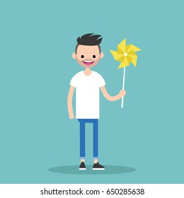 Young happy character holding a toy windmill / flat editable vector illustration, clip art