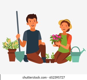 Young, happy couple gardening. Smiling man and woman work in garden and planting flowers. Family fun in summer