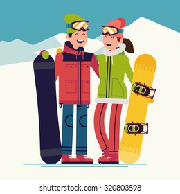 Young happy couple of snowboarders adult boy and girl | Young man and woman in winter ski wear standing holding snowboards wearing goggles laughing happily on snow mountain landscape background