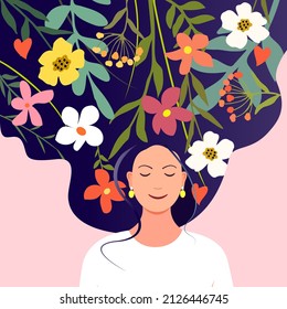 Young happy dreaming woman with flowers and herbs on long hair background. The concept of female beauty, mental health, joy, approval, happiness. Psychology and tranquility.