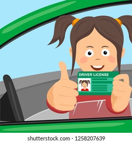 Young happy girl showing her new driver license