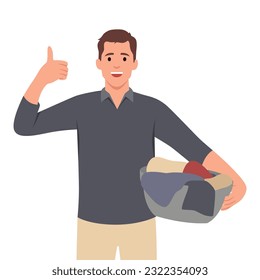 Young happy man holding laundry basket and detergent bottle and thumb up. Flat vector illustration isolated on white background