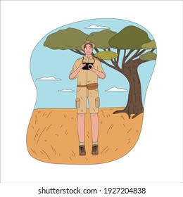Young happy man tourist traveler standing with photo camera during safari
