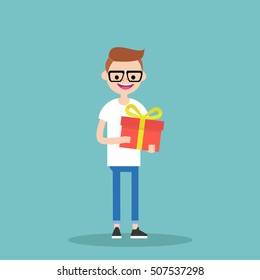Young happy nerd holding a bright gift box / editable vector cartoon clip art