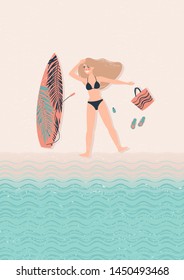 young happy woman blonde in a bathing suit lies on the beach and relax next to her surfboard. Surfers.