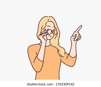 Young happy woman wearing eyeglasses pointing over white background. Hand drawn style vector design illustrations.