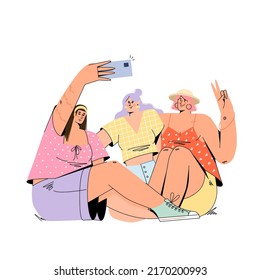 Young happy women take a selfie photo hugging their friends sitting on the grass.