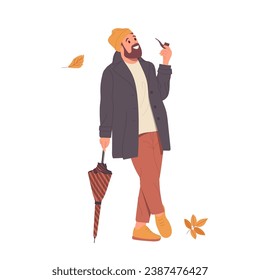 Young hipster man walking in autumn street smoking pipe enjoying warm weather season and defoliation