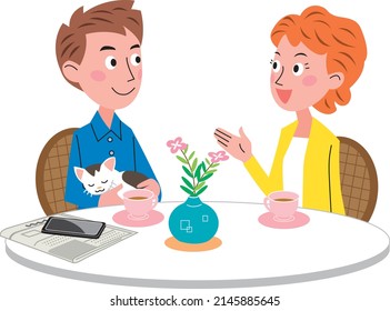A young husband and wife holding a cat are chatting at the table. There are coffee cups, vases, newspapers and husband's smartphone on the table.
