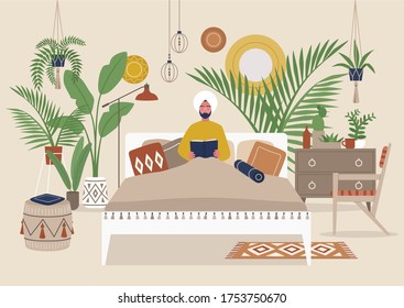 Young indian male character reading a book in bed, cozy detailed boho style bedroom interior, millennial lifestyle