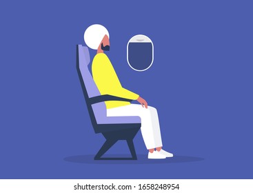 Young indian male passenger sitting on board an airplane, travel concept, millennial lifestyle