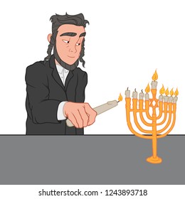 Young jewish man lights the candles on menorah, Hanukkah