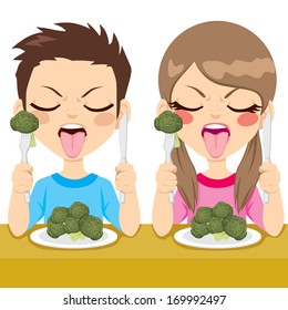 Young kids sitting on dinner table eating healthy broccoli making funny disgusted face