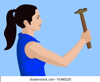 Young lady with a hammer in hand on blue