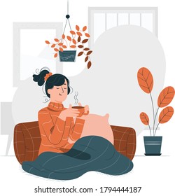 jovencita sentada en el suelo. Mujer sentada en el suelo con cojines tomando café. 