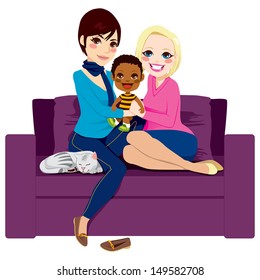 Young lesbian couple sitting on a couch holding and hugging adopted african baby