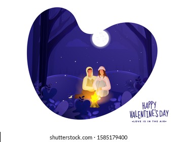 Young Loving Couple Sitting in Front of Bonfire on Paper Cut Heart Shaped Nature Night Scene Background for Happy Valentine's Day Celebration.