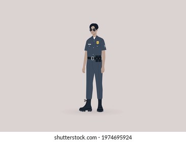 A young male Asian police officer on duty wearing a uniform and sunglasses