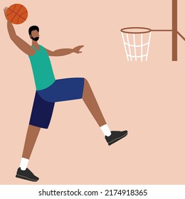 Young male basketball player throwing ball into basket while jumping
