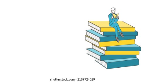 A young male businessperson is reading a book. Next to him is a copy space.