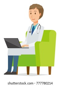 A young male doctor wearing a white suit sitting on a sofa and operating a laptop computer