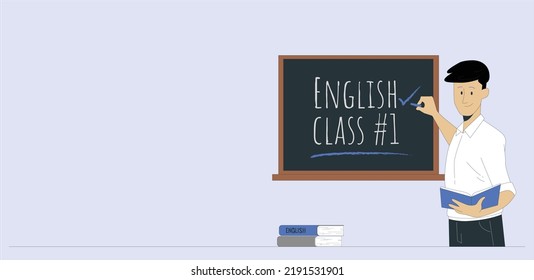 Young male English language teacher standing in front of black board. Close-up of a male teacher writing English words on the blackboard. Young teacher near chalkboard in school classroom