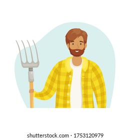 A young male farmer in a checked shirt with a haystack in his hands. The season of harvest. Grain growing and animal husbandry. Subsistence farming.