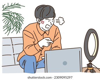 Young male influencer broadcaster angry in front of laptop
