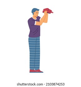 Young male in need of money, isolated, flat vector illustration. Unhappy man stands and turns his empty wallet upside down, showing that it has no money.