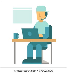 Young male programmer working on a laptop near a window. Young man sitting on a chair near a table