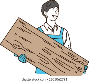 
Young man in apron holding wood