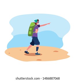 young man with backpack walking sand