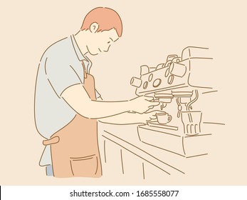 A young man barista is wearing an apron and making coffee.