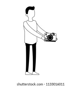 Young man with camera faceless black and white colors