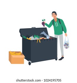 Young man collecting fruits and vegetables from waste container or trash bin. Male freegan searching for leftover food in dumpster. Cartoon character isolated on white background. Vector illustration.