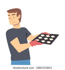 Young Man Cooking Pastries In The Kitchen, Guy Holding Tray With Buns Cartoon Style Vector Illustration