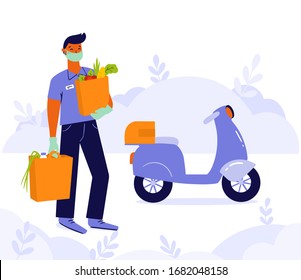 Young man, courier or volunteer in a medical mask and medical gloves delivers grocery products from the supermarket by motorbike. Non contact delivery to prevent the spread of the corona virus.