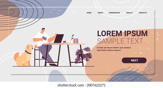 young man with credit card using laptop online shopping concept living room interior horizontal