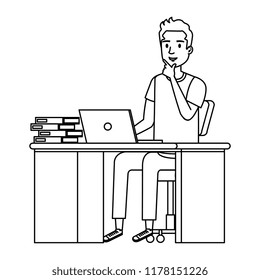 young man at desk with laptop and books