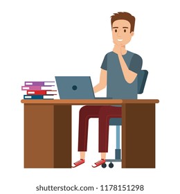 young man at desk with laptop and books