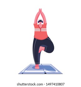 A young man does yoga on a yoga mat on a white background. 