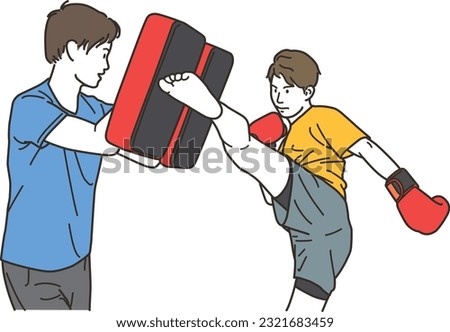 Young man doing martial arts kicks and male trainer with mitts
